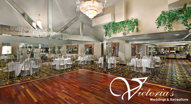 Interior banquet and reception hall with a chandelier and wood dance floor