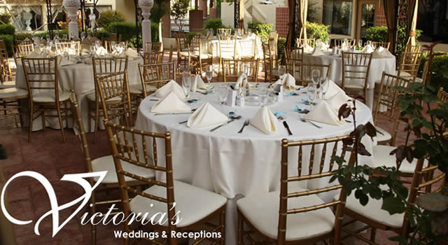 A set reception table with gold chiavari chairs